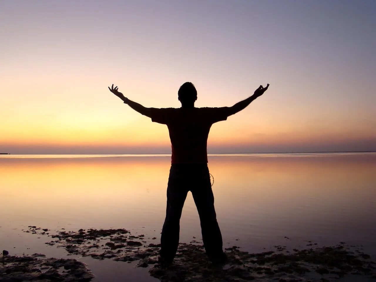 Silhouette of a person walking at sunrise