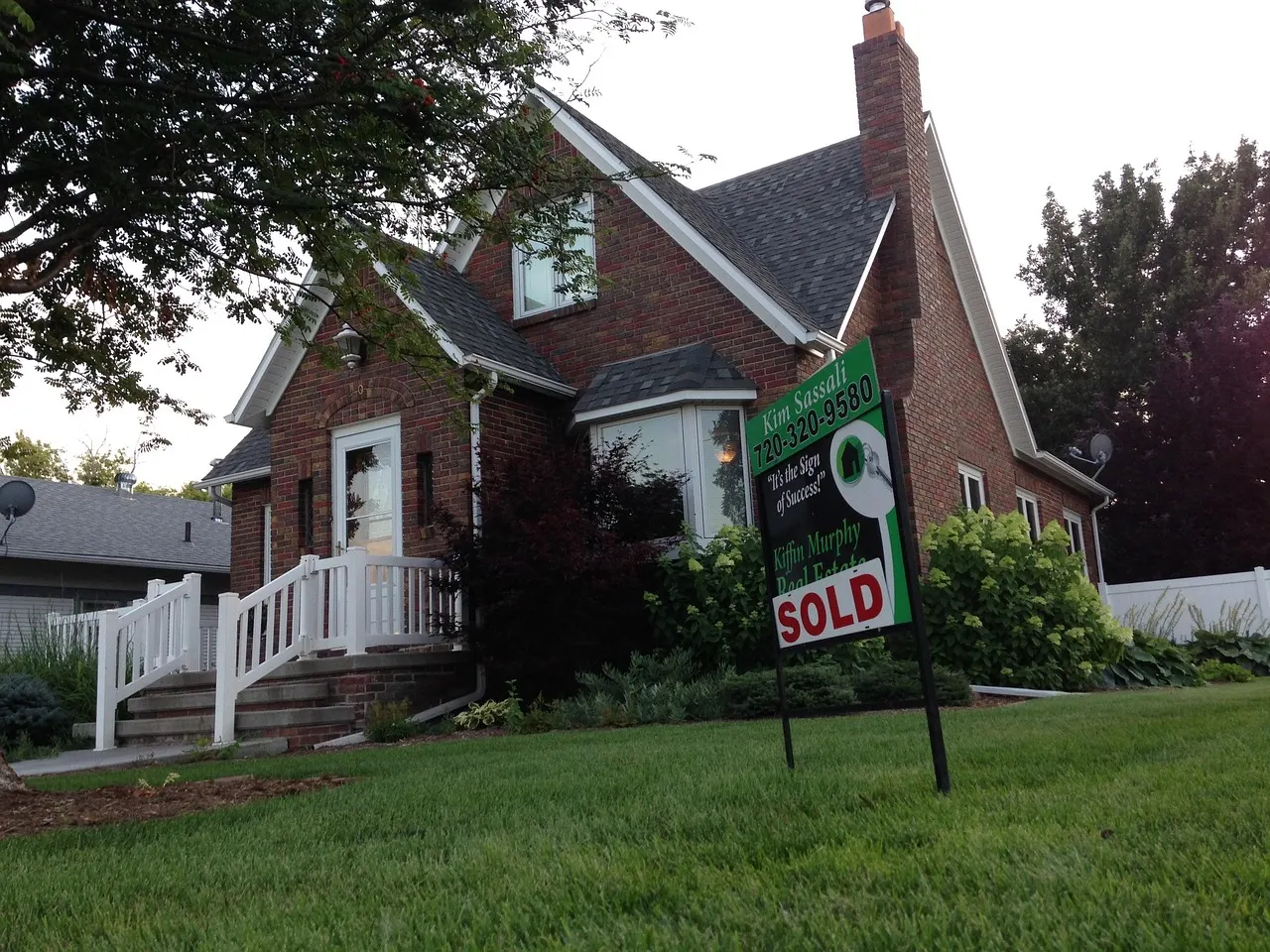 A suburban street with multiple for sale signs, representing the stalled housing market