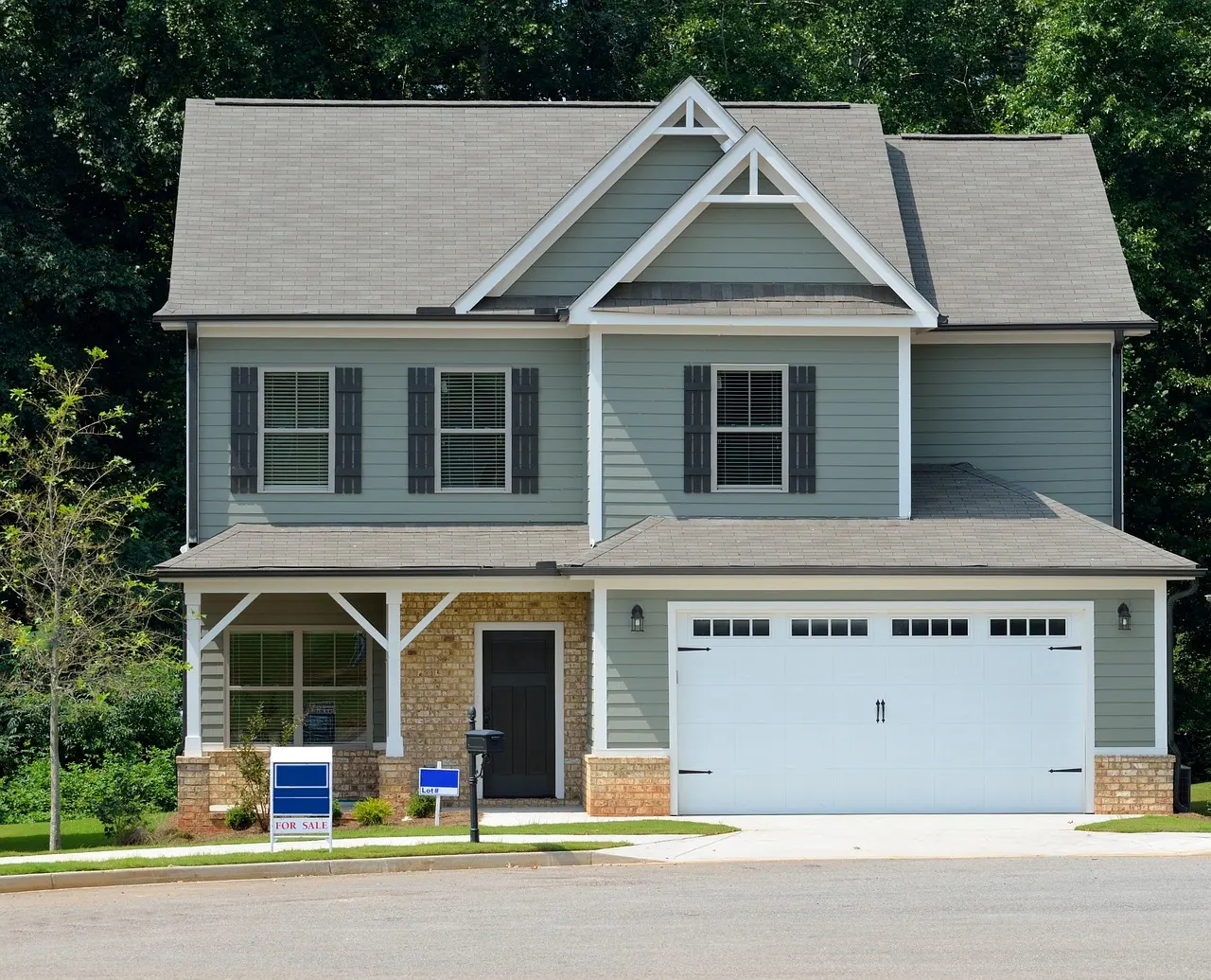 Suburban home with a for sale sign in the yard