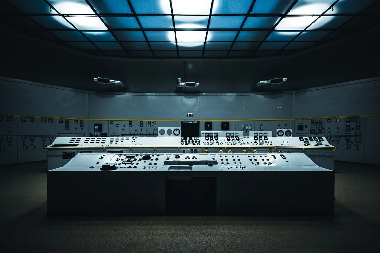 Industrial control room with multiple monitors displaying water system data