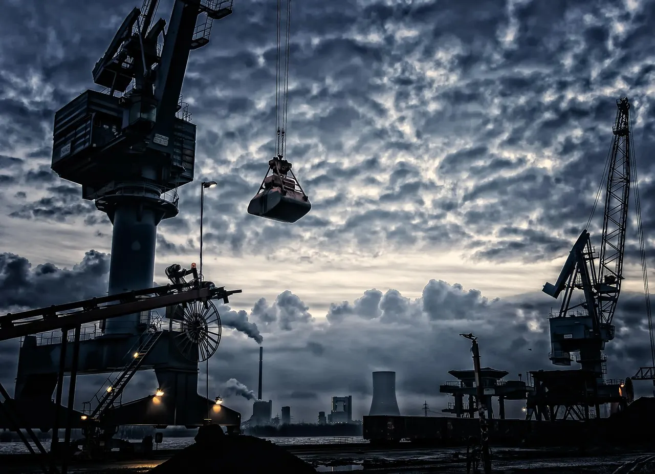 Stacked shipping containers at a U.S. port at dawn
