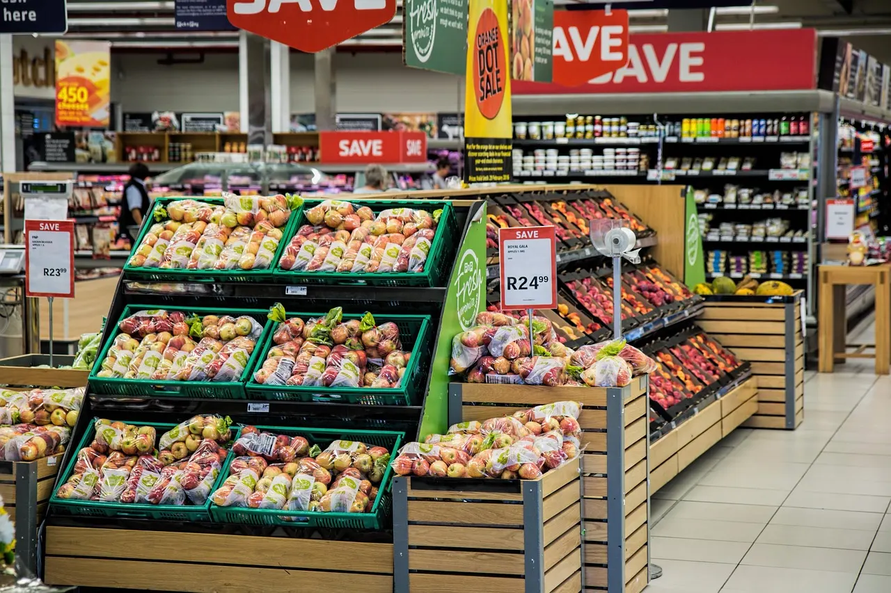 A family comparing prices in a retail aisle